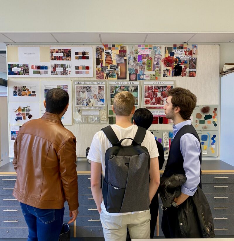 People looking at sketches in an exhibition